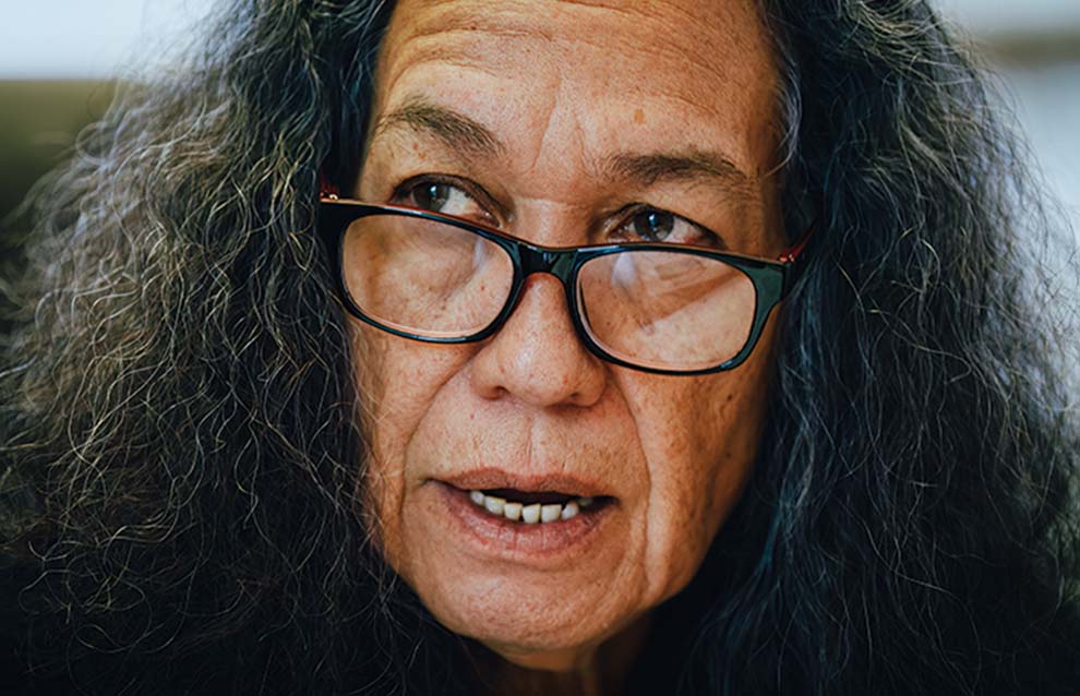 a person with long hair wearing glasses